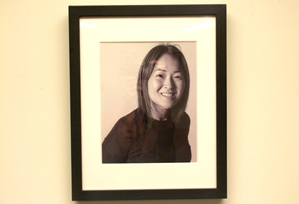photo of young Asian American woman in black frame and white matte